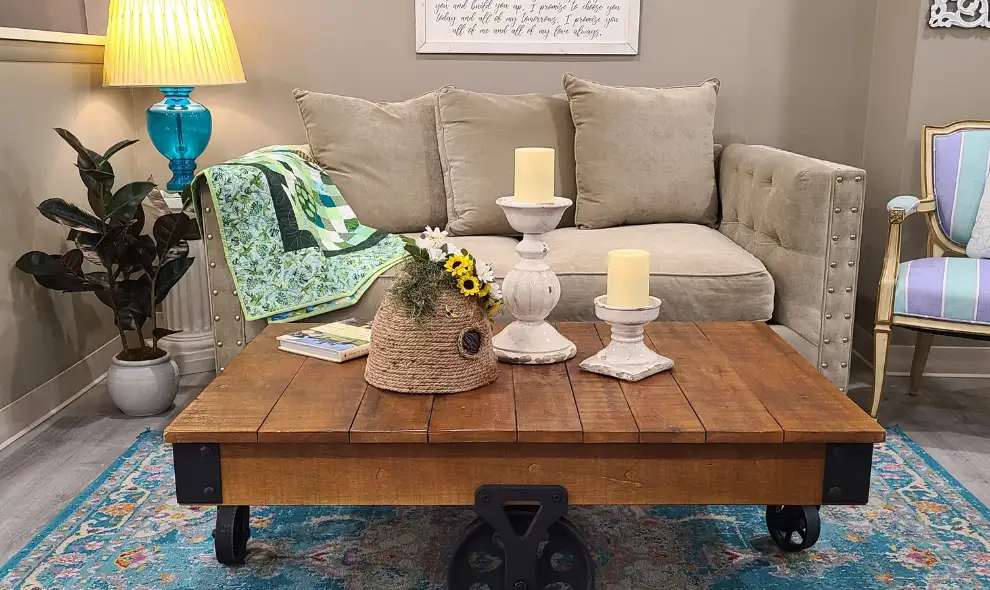 Re-Uzit Shop New Holland PA furniture and home decor display with rustic coffee table and Amish quilt