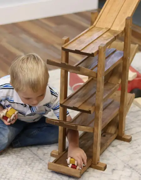 Child playing with Amish handcrafted wooden marble run toy in Lancaster County PA
