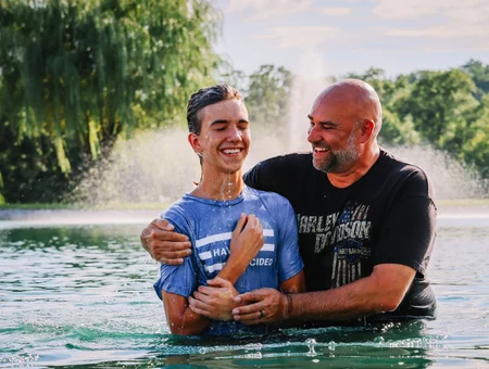 Victory Church Lancaster PA pastor baptizing young man outdoors in water