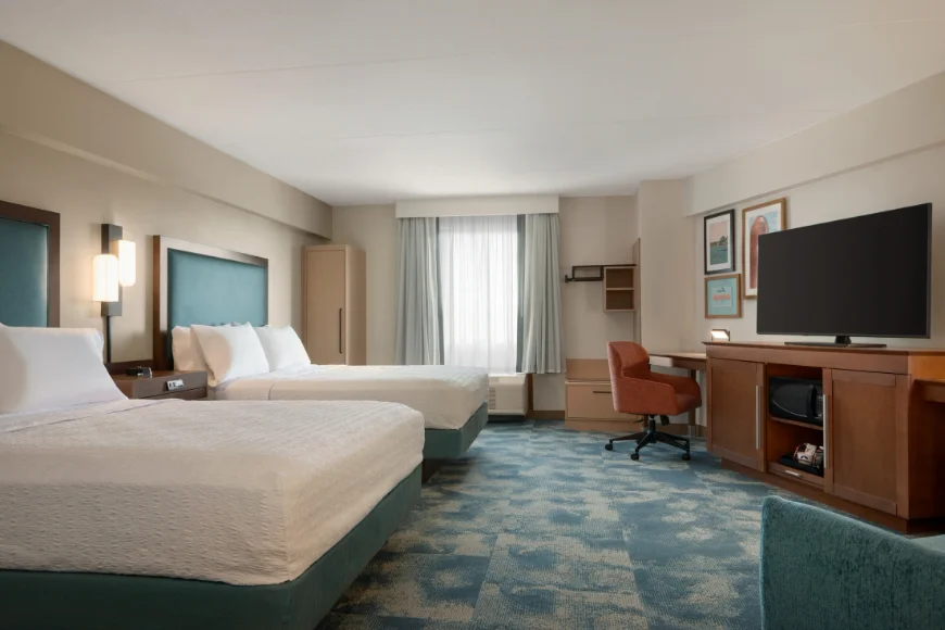 Double queen guest room with desk and TV at Hampton Inn Lancaster PA
