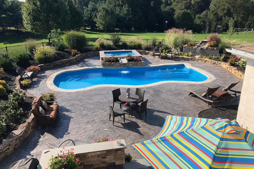 Custom pool and stamped concrete patio with spa built by Luxscapes Unlimited in Lancaster County PA