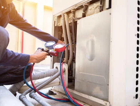 HVAC technician servicing an air conditioning unit for Ressler and Mateer, Lancaster PA