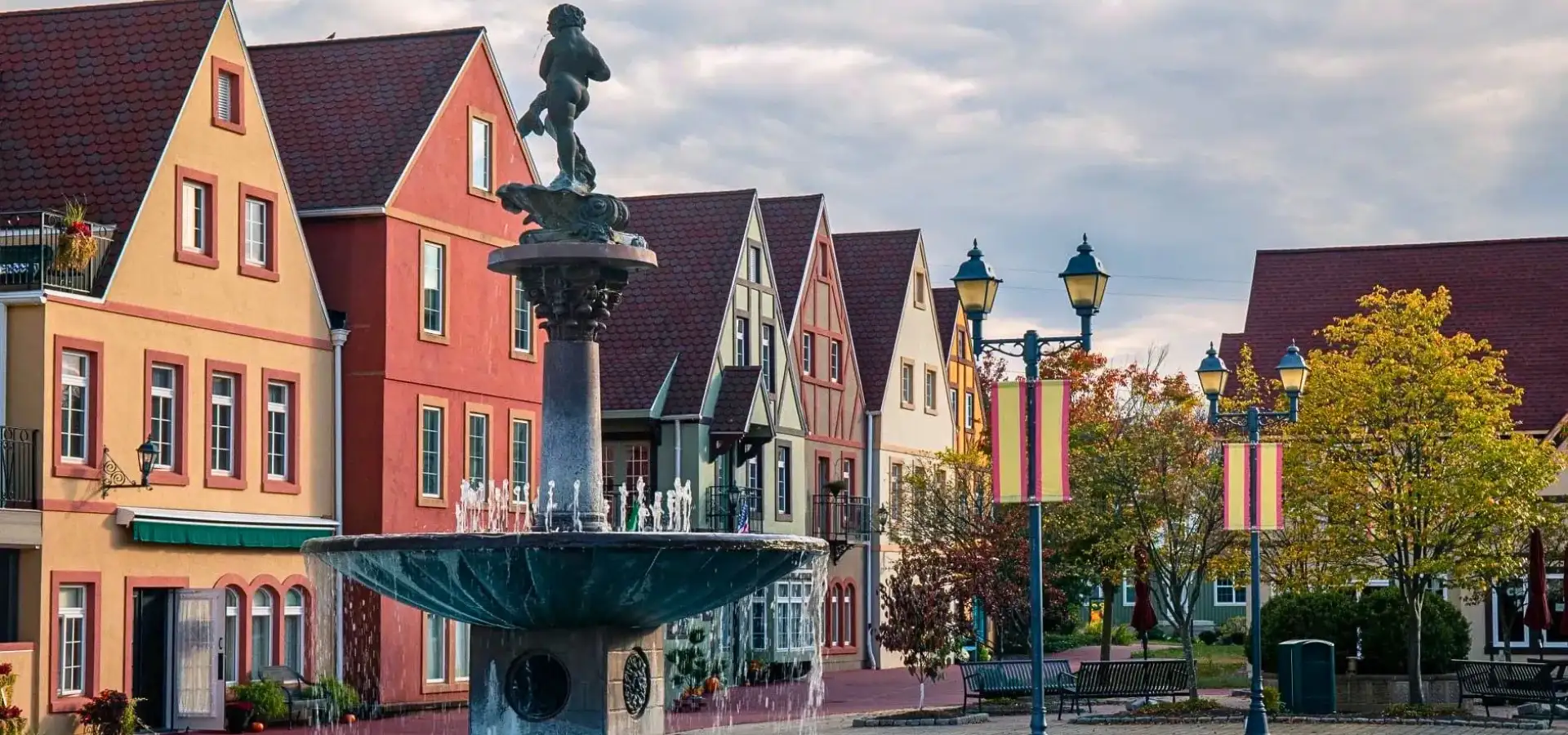 Fountain and colorful Bavarian style buildings at Stoudtburg Village in Adamstown PA