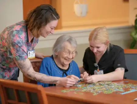 Landis at Home assisted living staff working on puzzle with resident in Lancaster PA