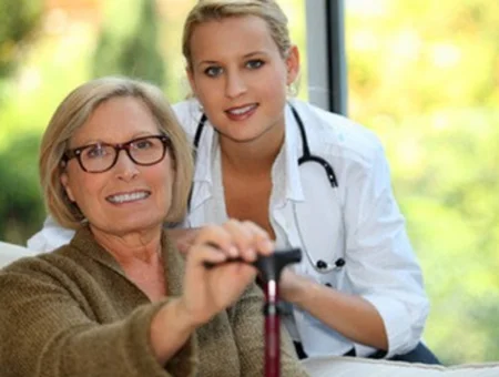 Older woman with a cane being assisted by a healthcare worker, used in a Bagnall Shaw Insurance ad