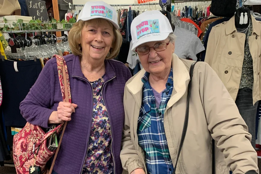 Two women wearing tour stop hats shopping at a store on the Best Kept Secrets Tour in Lancaster PA