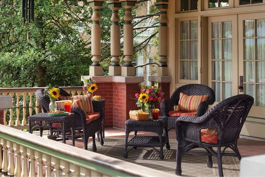 Wicker chairs and flowers on covered front porch at B.F. Hiestand House Bed and Breakfast in Lancaster PA