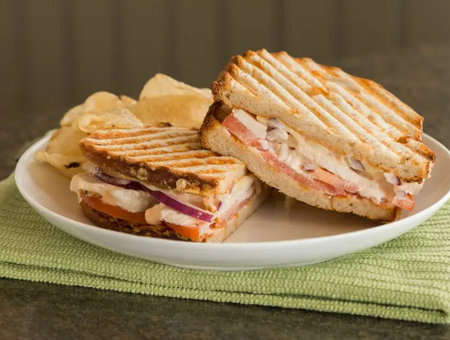Grilled panini sandwich with chips at Bird-in-Hand Bakery and Cafe Lancaster PA