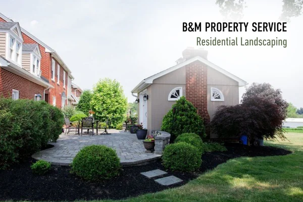 Backyard patio with mulched garden bed by B&M Property Service in Lancaster, Pennsylvania