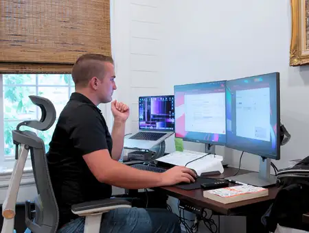 eImpact business services professional working at multi monitor desk setup in Lancaster PA