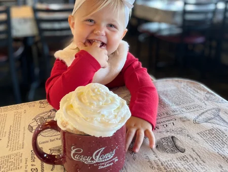 Child enjoying hot chocolate with whipped cream at Casey Jones Restaurant Lancaster PA