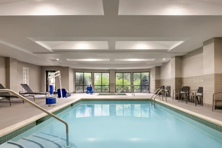 Indoor pool with lift and lounge seating at Courtyard by Marriott Lancaster PA