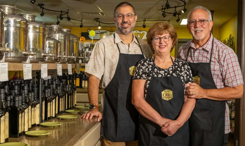 Owners standing among tasting bottles at Olio Olive Oil and Balsamic in Lititz PA