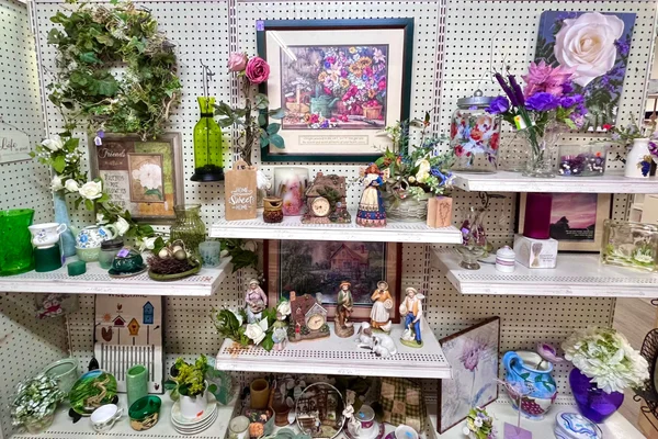 Shelves of framed art, figurines, and home decor at Freedom Thrift in Lancaster PA