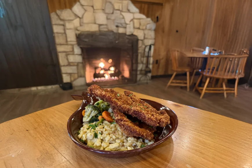 Fried chicken tenders with broccoli and spaetzle by the fireplace at Smokehouse at Plain & Fancy Farm in Lancaster PA