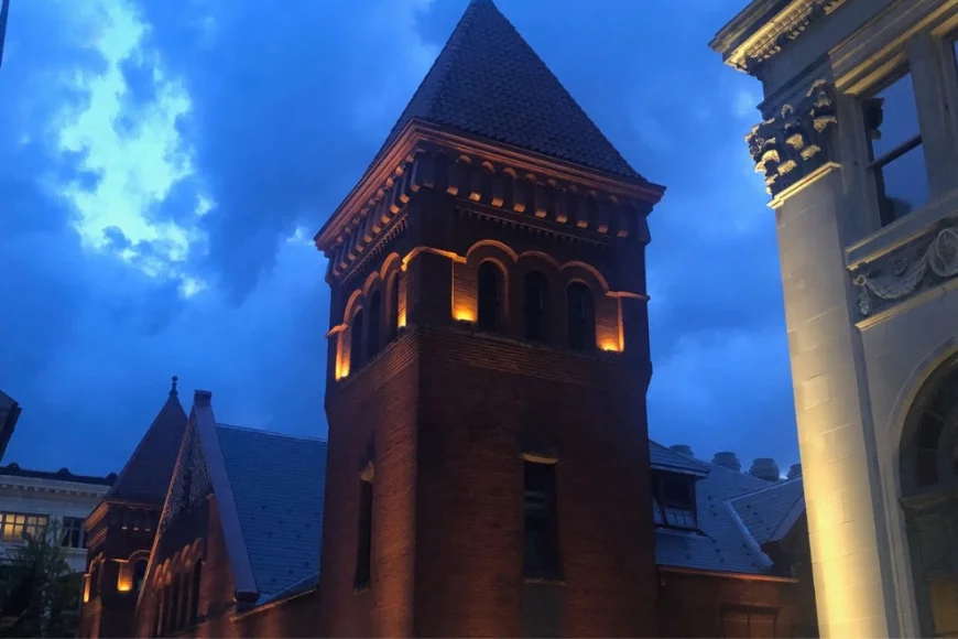 Illuminated brick clock tower against a dusk sky on a Ghost Tours of Lancaster PA route