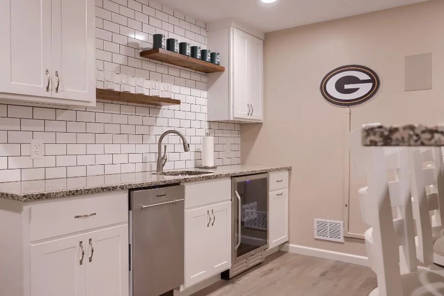 Basement kitchenette with subway tile backsplash and mini fridge by S King Home Improvement in Lancaster County PA