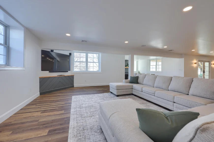Basement family room with large sectional sofa and mounted TV by S King Home Improvement in Lancaster County PA