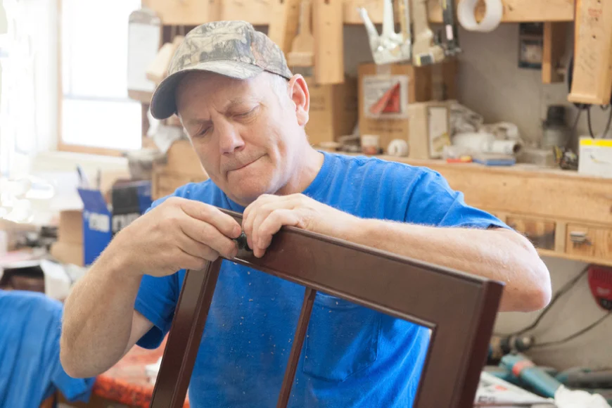 Craftsman assembling a wooden chair frame at George's Furniture in Lancaster County PA