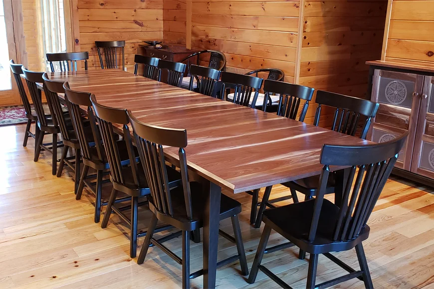 Long dining table with black chairs seating twelve from George's Furniture in Lancaster County PA