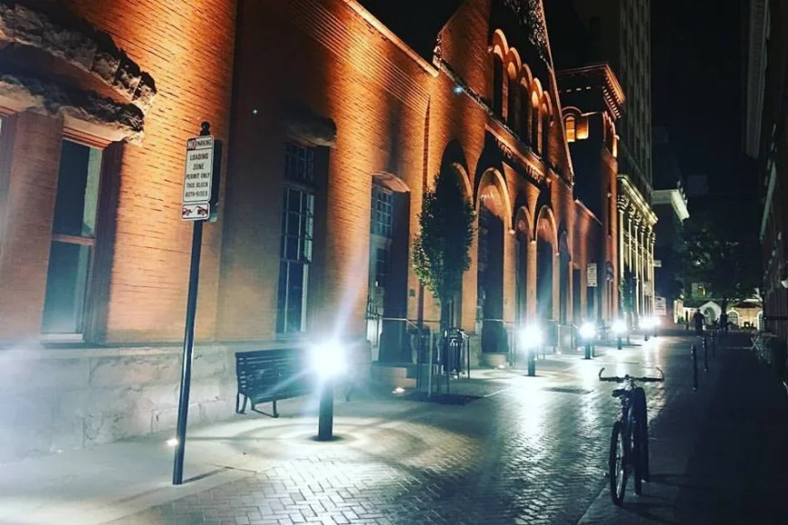 Historic brick building lit up on cobblestone walkway at night in downtown Lancaster PA