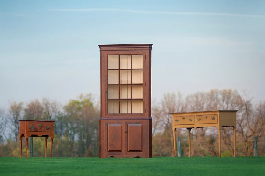 Handcrafted corner cupboard and accent tables displayed outdoors at Great Windsor Chairs Lancaster PA