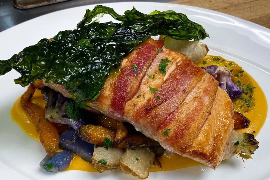 Bacon wrapped salmon with roasted vegetables and golden sauce at Greenfield Restaurant Lancaster PA