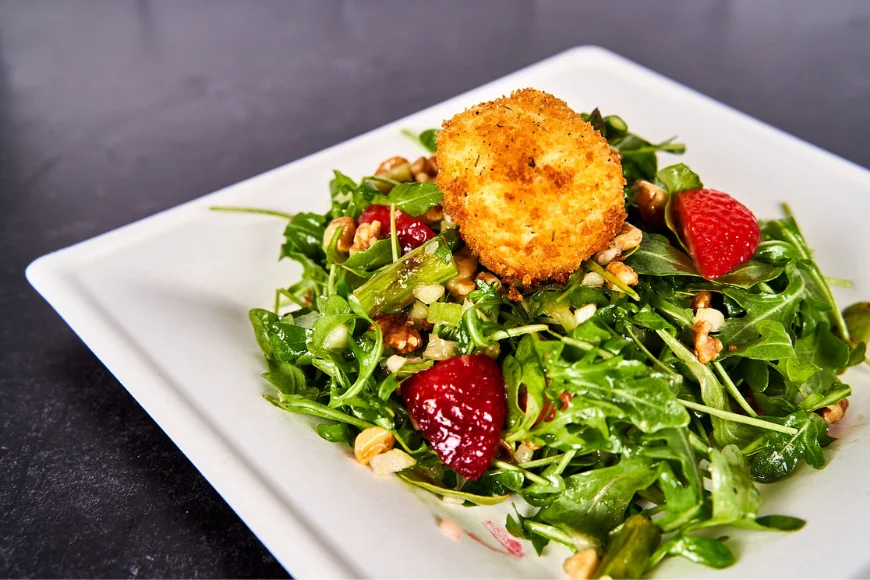Arugula salad with fried goat cheese strawberries and walnuts at Harvest Cafe Kitchen Kettle Village Intercourse PA