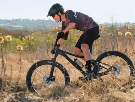Martins Bike and Fitness mountain biker riding through field trail in Lancaster PA