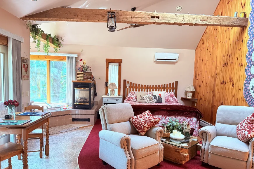 Bedroom with fireplace and armchairs at Hillside Farm Bed and Breakfast in Lancaster PA