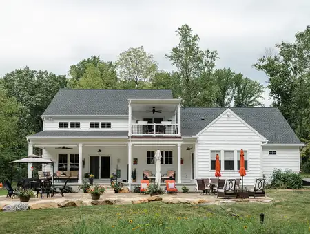 White farmhouse style home with covered porch and outdoor patio in Lancaster County PA