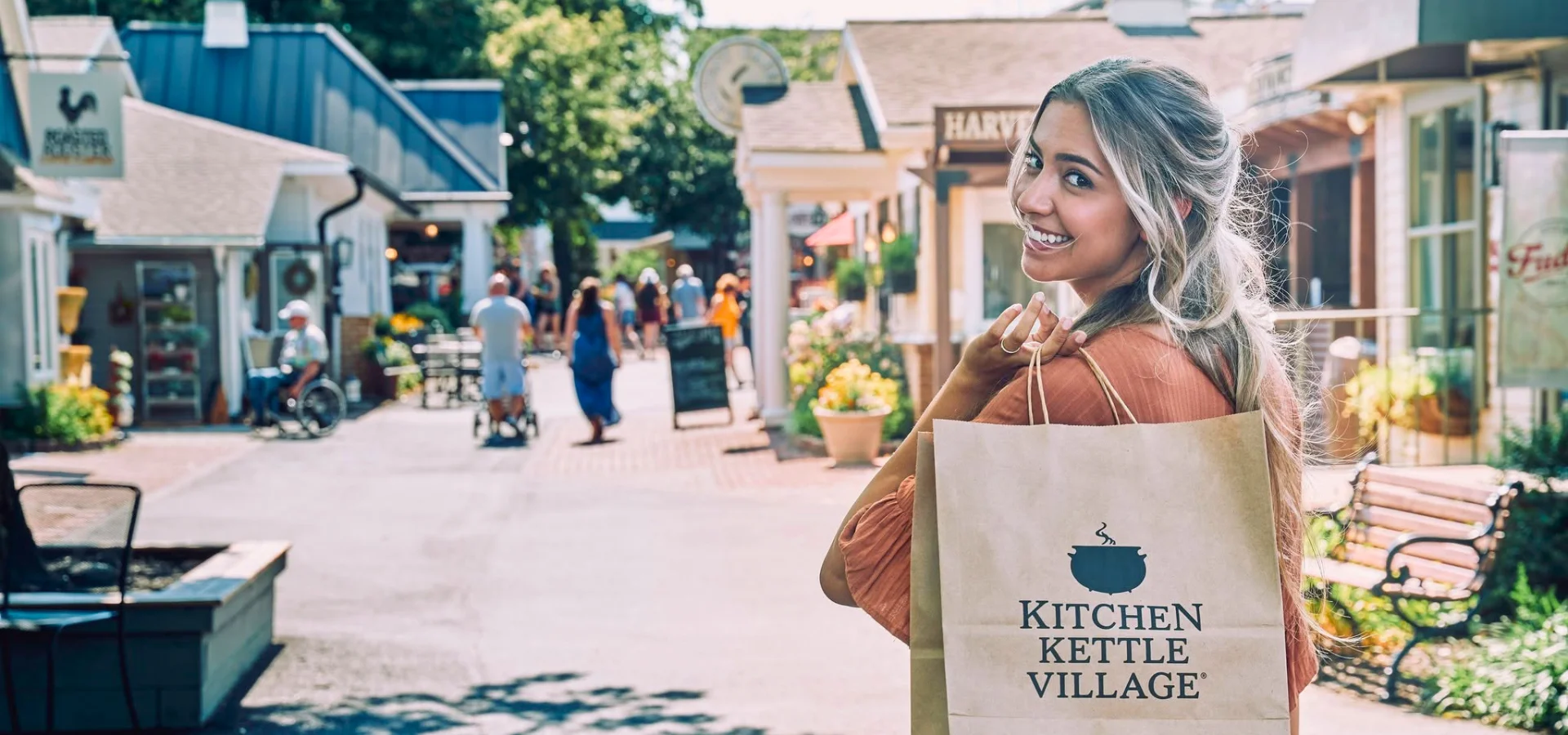 Woman shoppng at Kitchen Kettle Village, an outdoor shopping village, home page hero image for LancasterPA.com shopping