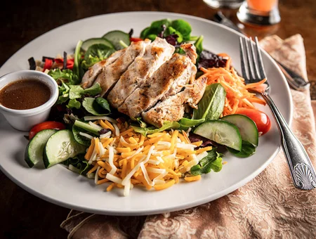 Grilled chicken salad with shredded cheddar cucumbers and dressing at Huckleberry's Restaurant and Tavern Lancaster PA