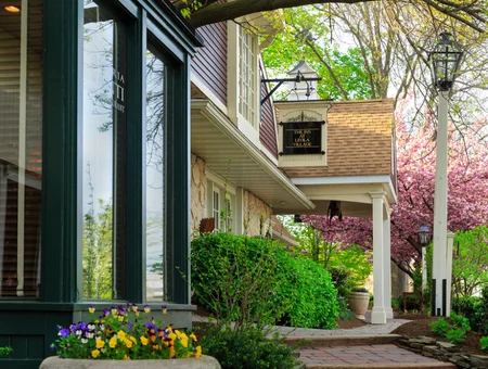Entrance porch with cherry blossoms and flower boxes at The Inn at Leola Village in Lancaster PA