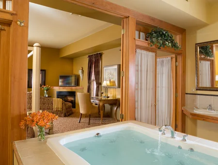 Whirlpool tub open to sitting area with fireplace at The Inn at Leola Village in Lancaster PA