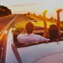 Couple driving a convertible at sunset representing auto insurance from Bagnall Shaw in Lancaster PA