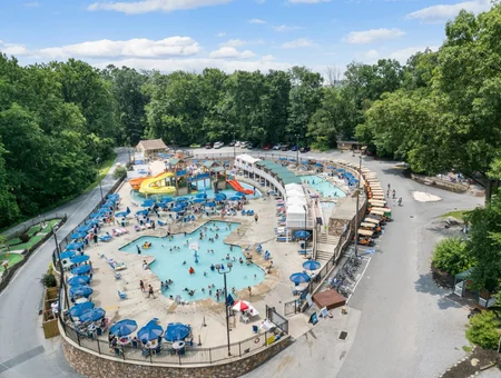 Aerial view of resort pool complex with water slide at Jellystone Park Quarryville in Lancaster PA