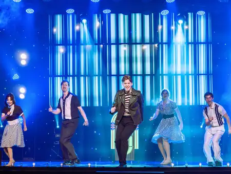 Jukebox Generation cast dancing on stage at Magic and Wonder Dinner Theater in Lancaster PA