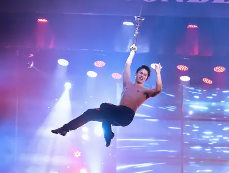 Jukebox Generation aerial acrobat performer swinging on stage at Magic and Wonder Dinner Theater in Lancaster PA