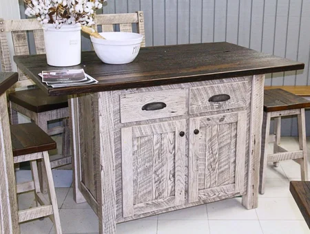 Whitewashed wood kitchen island with dark top and matching stools