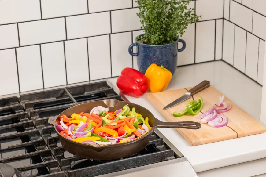 Peppers and onions cooking in a Lancaster Cast Iron skillet on the stove made in Pennsylvania