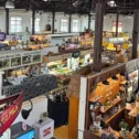 Aerial view of Central Market's interior in downtown Lancaster, PA, showing multiple food vendor stalls with produce, meats, and baked goods