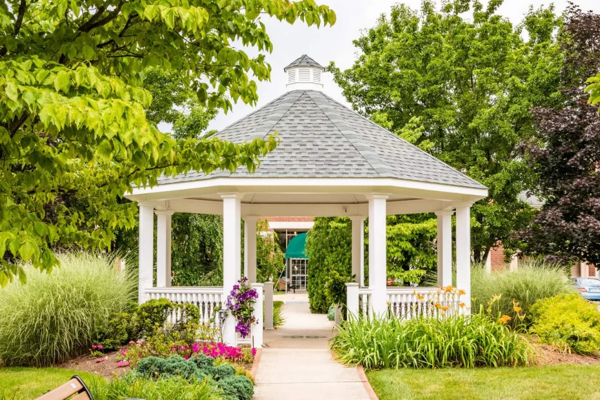 White gazebo surrounded by garden landscaping in a Lancaster County PA backyard
