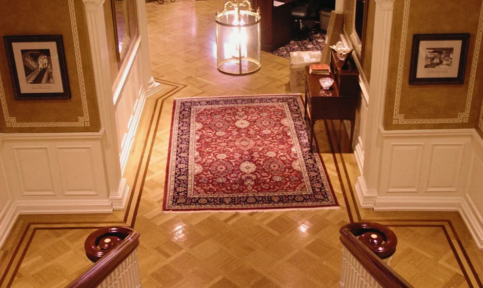 Parquet floor entryway with area rug, staircase railings, and antique furniture, Lancaster PA home improvement
