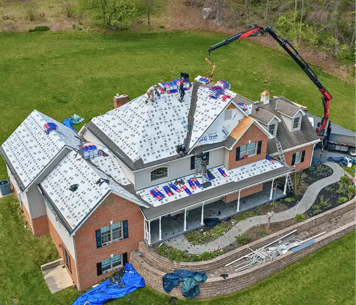 Aerial view of roofers installing new roof on brick home in Lancaster PA