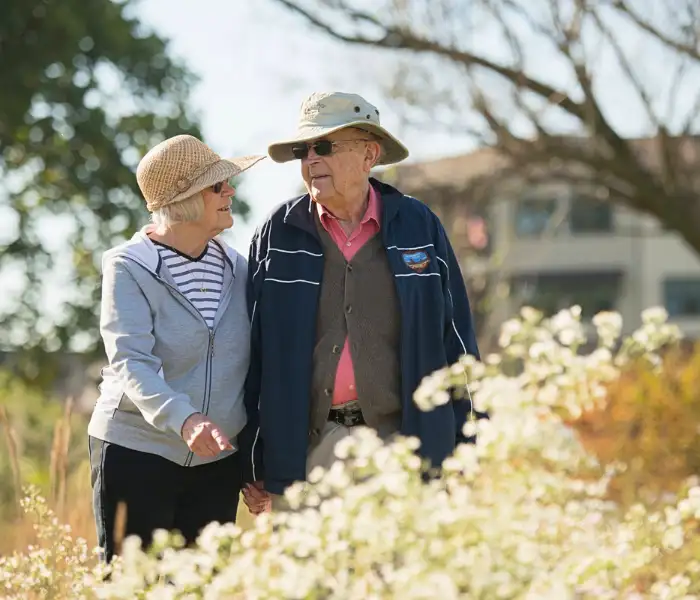 Elderly couple walking together through wildflowers for Landis at Home senior services in Lancaster PA