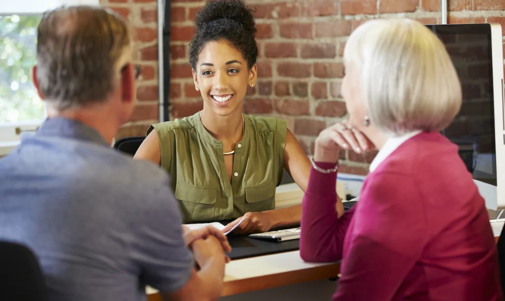 Insurance agent meeting with clients at desk, Bagnall Shaw insurance agency Lancaster County PA