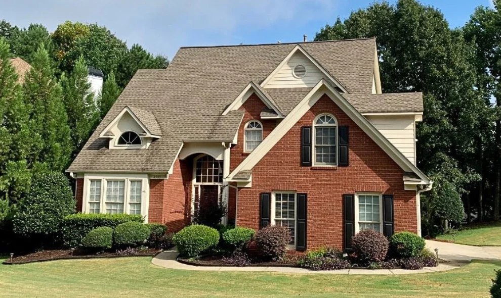 Brick two story home with shingle roof and mature landscaping, Lancaster PA roofing contractor
