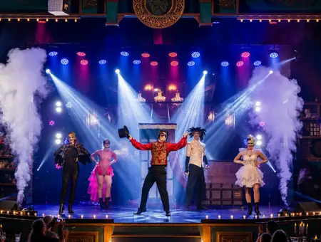 Magic and Wonder Dinner Theater cast performing on stage in Lancaster PA with fog and colorful stage lighting