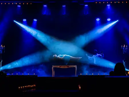 Levitation illusion performed under blue stage lights at Magic and Wonder Dinner Theater in Lancaster PA